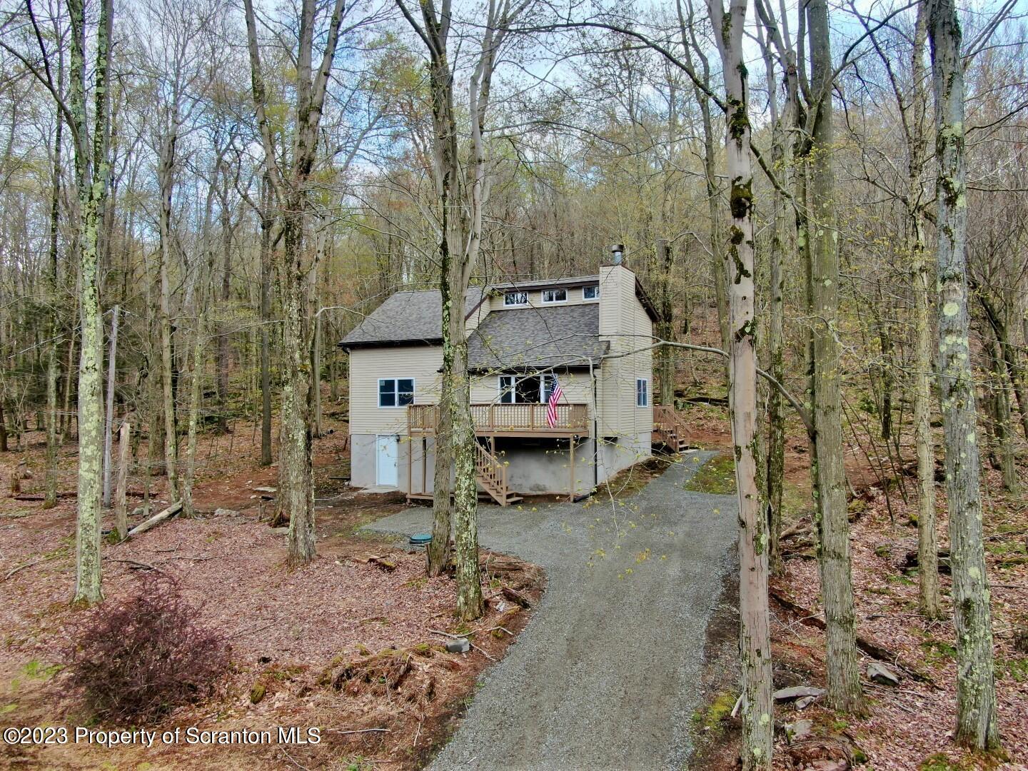 1013 Hemlock Way Newfoundland, PA 18445 - Photo 1 of 44 a view of a house with a backyard and trees