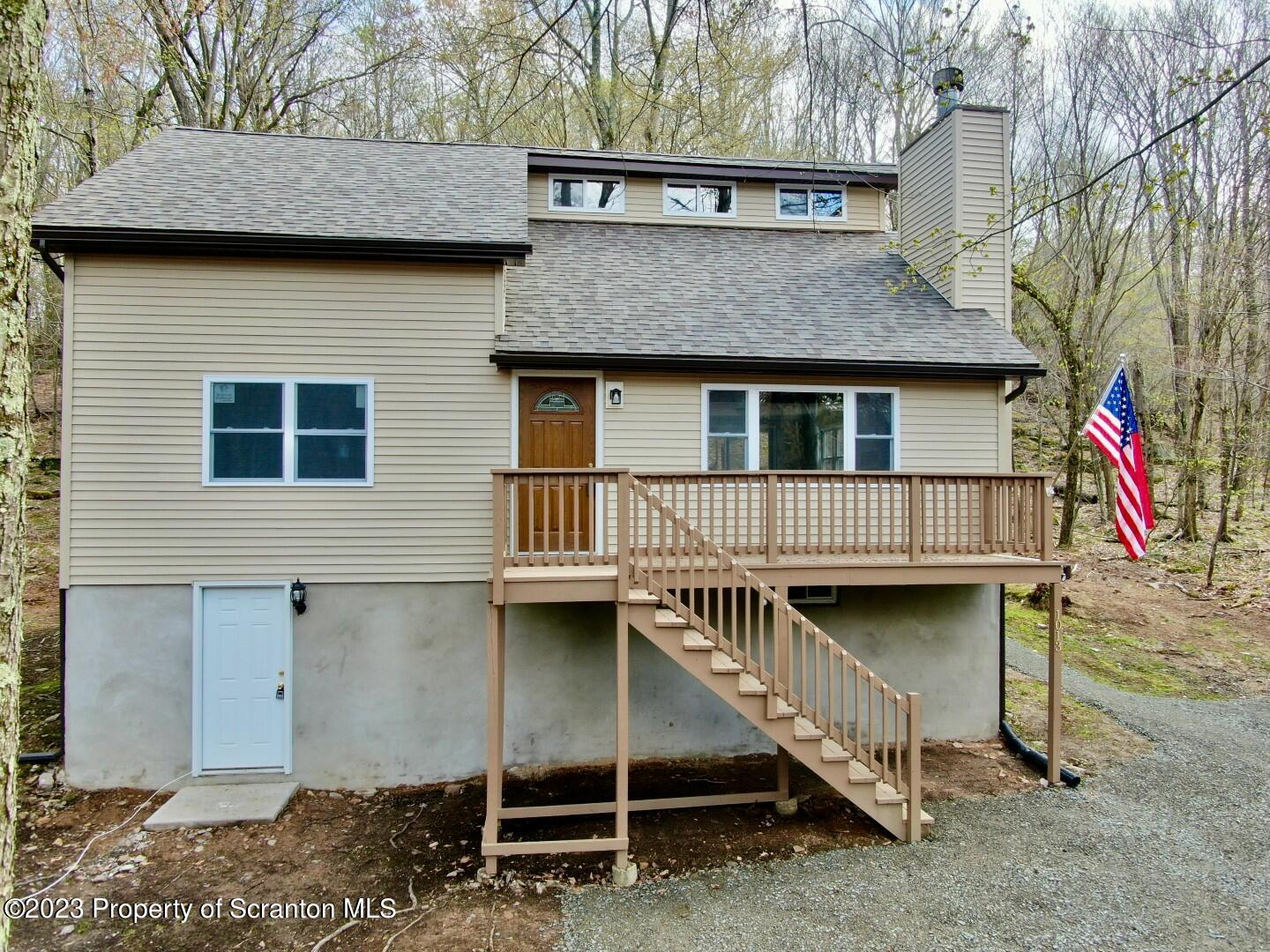 1013 Hemlock Way Newfoundland, PA 18445 - Photo 2 of 44 a view of a house with wooden deck front of house