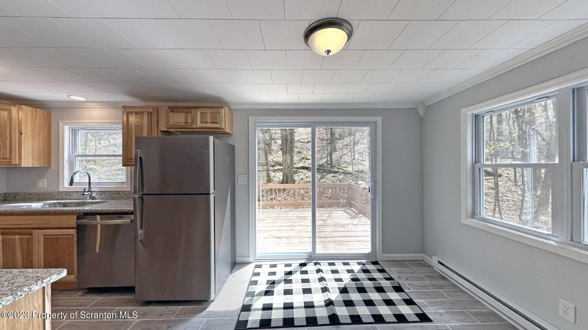 1013 Hemlock Way Newfoundland, PA 18445 - Photo 22 of 44 a kitchen with a refrigerator a sink and a window