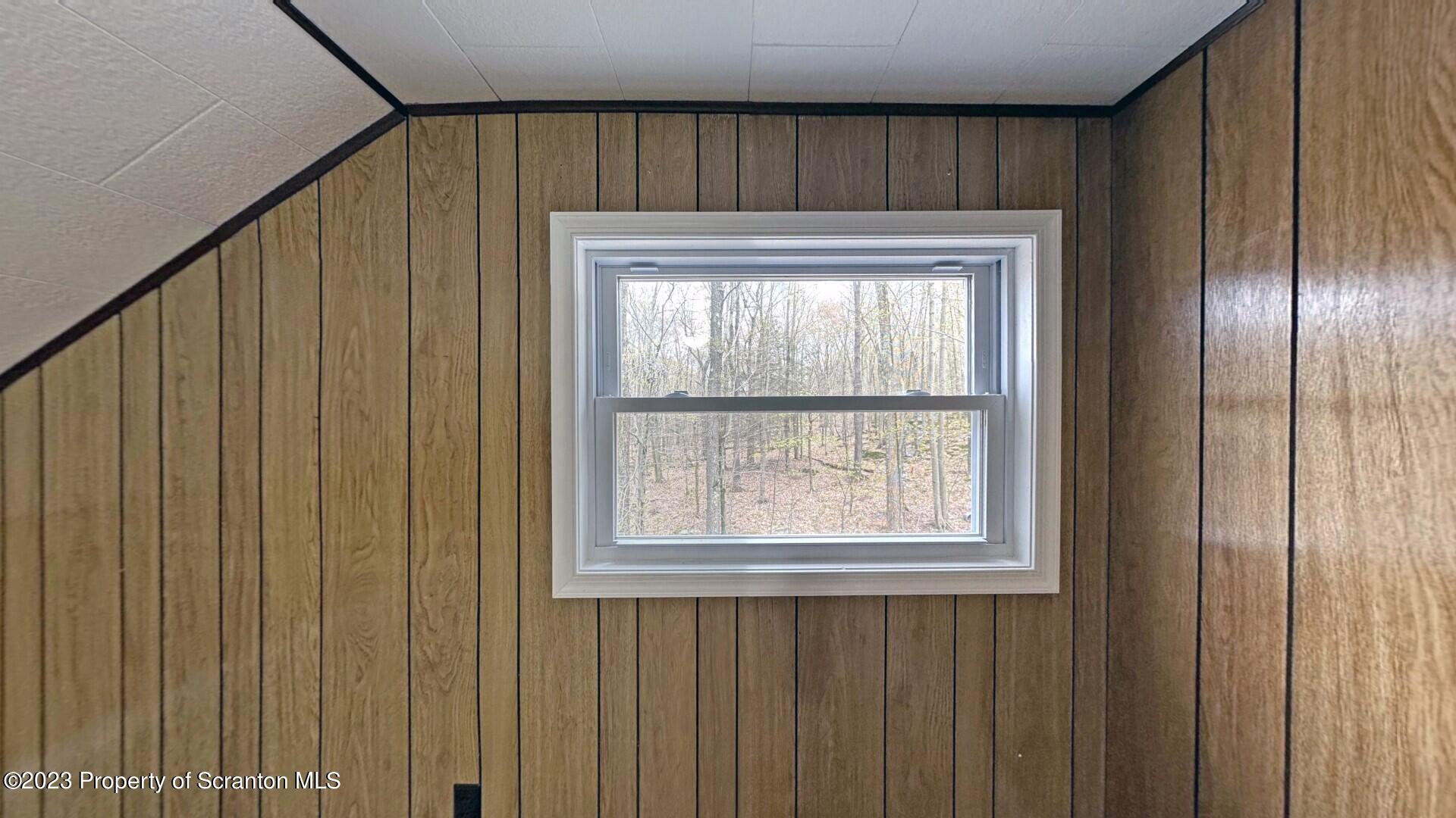 1013 Hemlock Way Newfoundland, PA 18445 - Photo 35 of 44 a bathroom with a window and a shower curtain