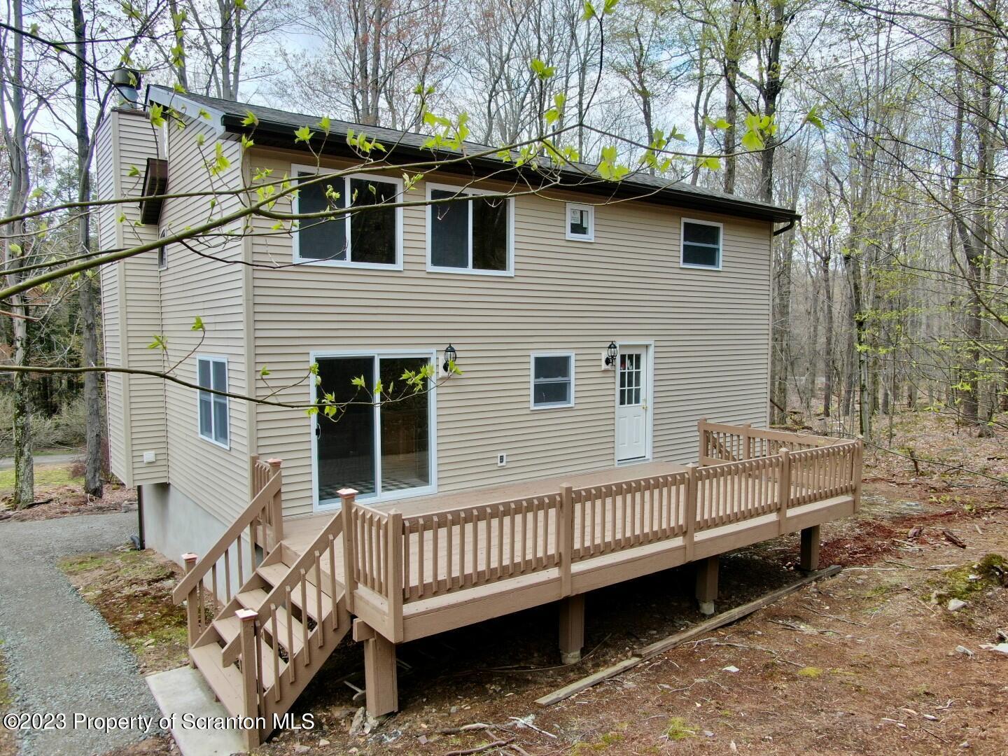 1013 Hemlock Way Newfoundland, PA 18445 - Photo 4 of 44 a view of a house with a wooden deck and a trees