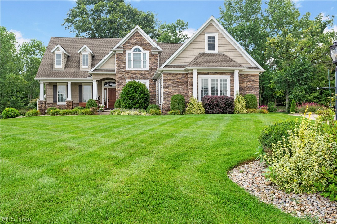 View of front of property featuring a porch and a front lawn