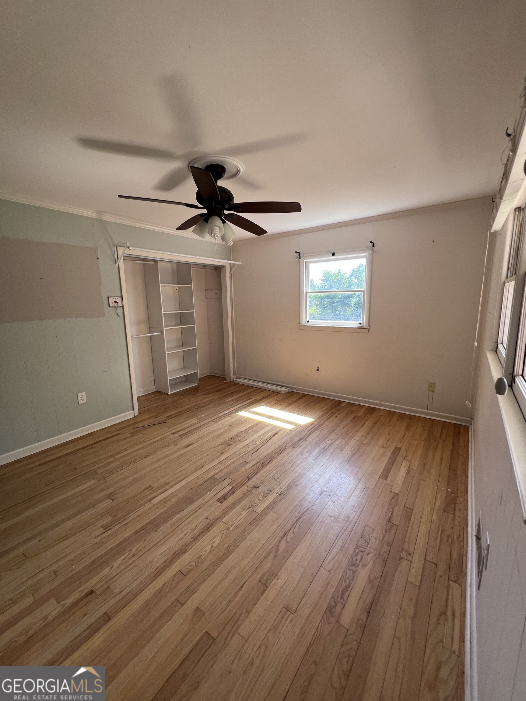 2205 Stonewall Street Dublin, GA 31021 - Photo 11 of 20 an empty room with wooden floor and windows