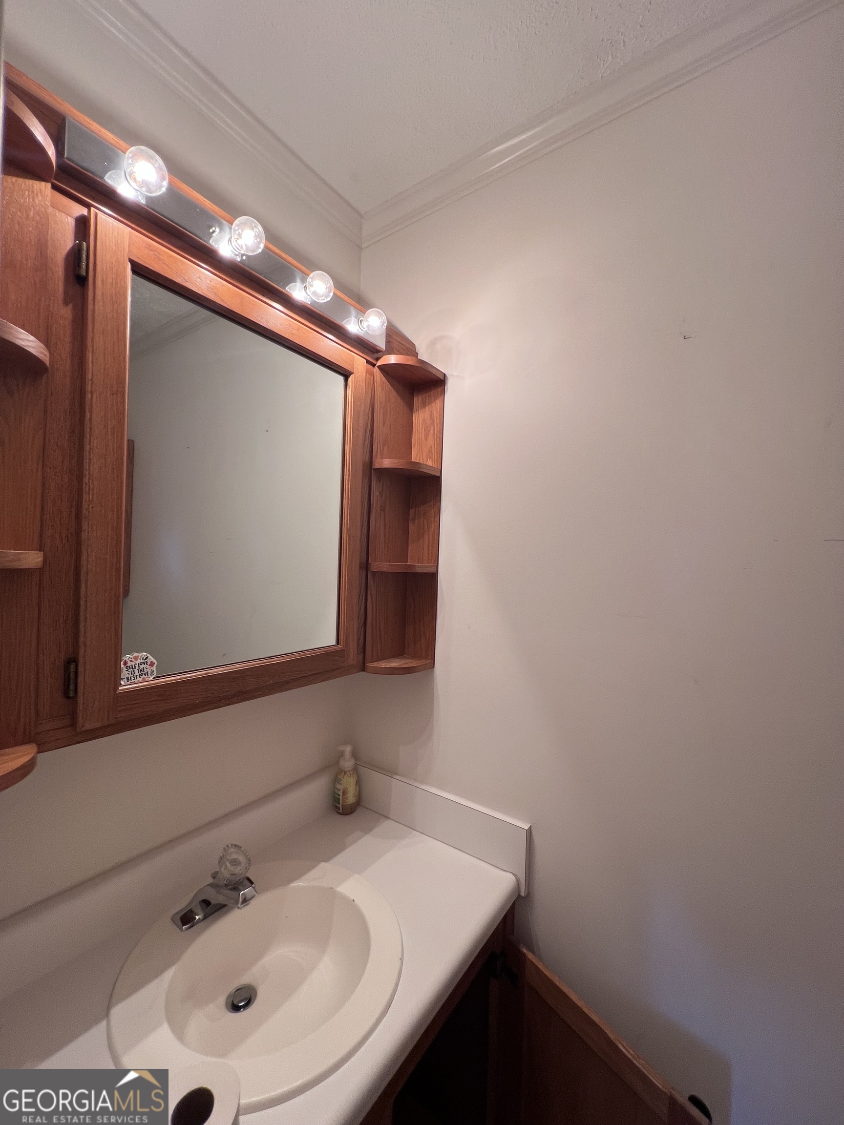 2205 Stonewall Street Dublin, GA 31021 - Photo 13 of 20 a bathroom with a sink and a mirror