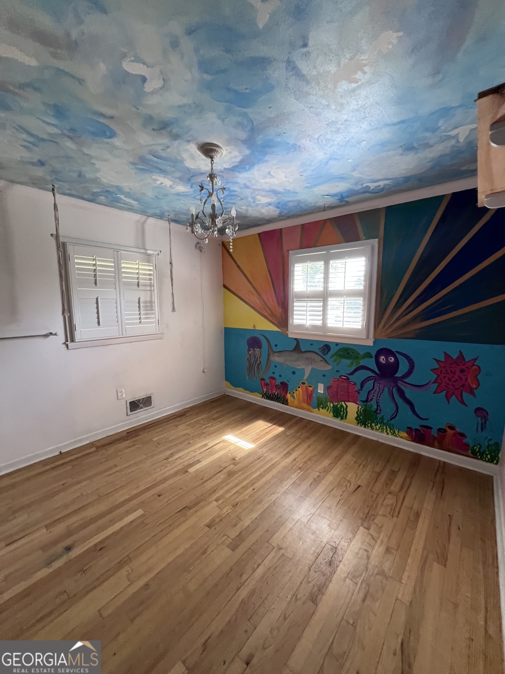 2205 Stonewall Street Dublin, GA 31021 - Photo 16 of 20 an empty room with wooden floor and windows