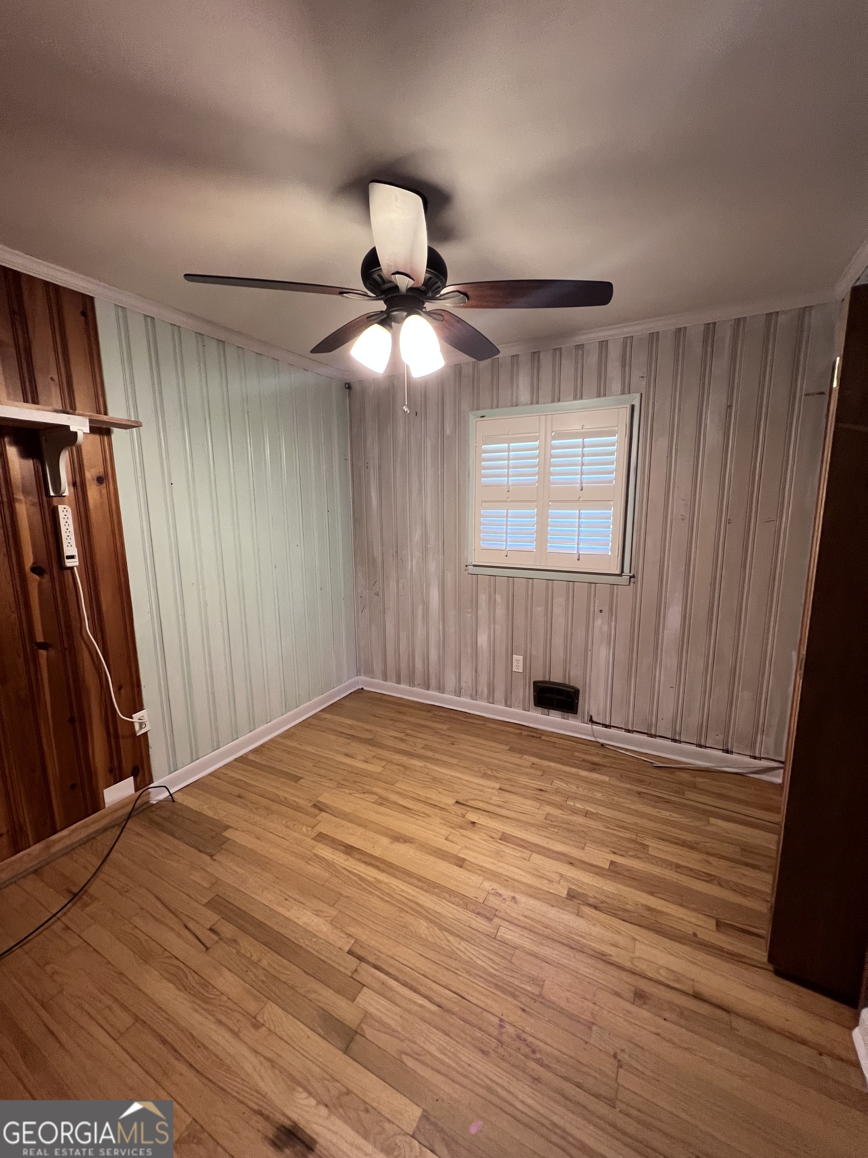 2205 Stonewall Street Dublin, GA 31021 - Photo 7 of 20 a view of an empty room with wooden floor and a window