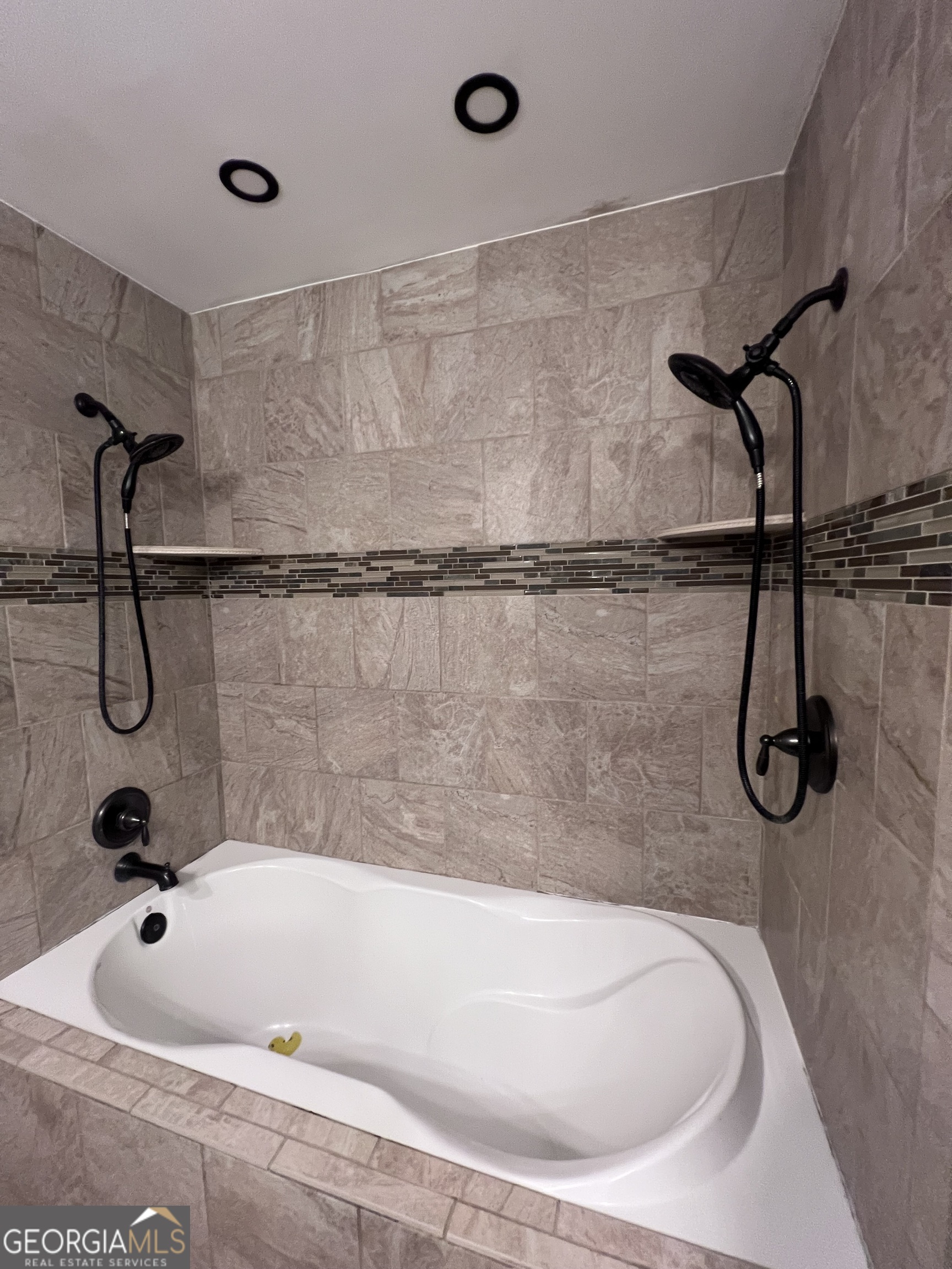 2205 Stonewall Street Dublin, GA 31021 - Photo 10 of 20 a bathroom with a bath tub with a shower