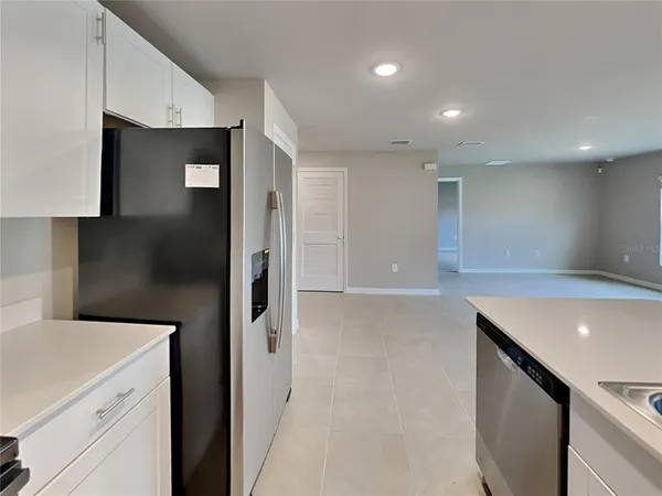 a kitchen with a sink and refrigerator