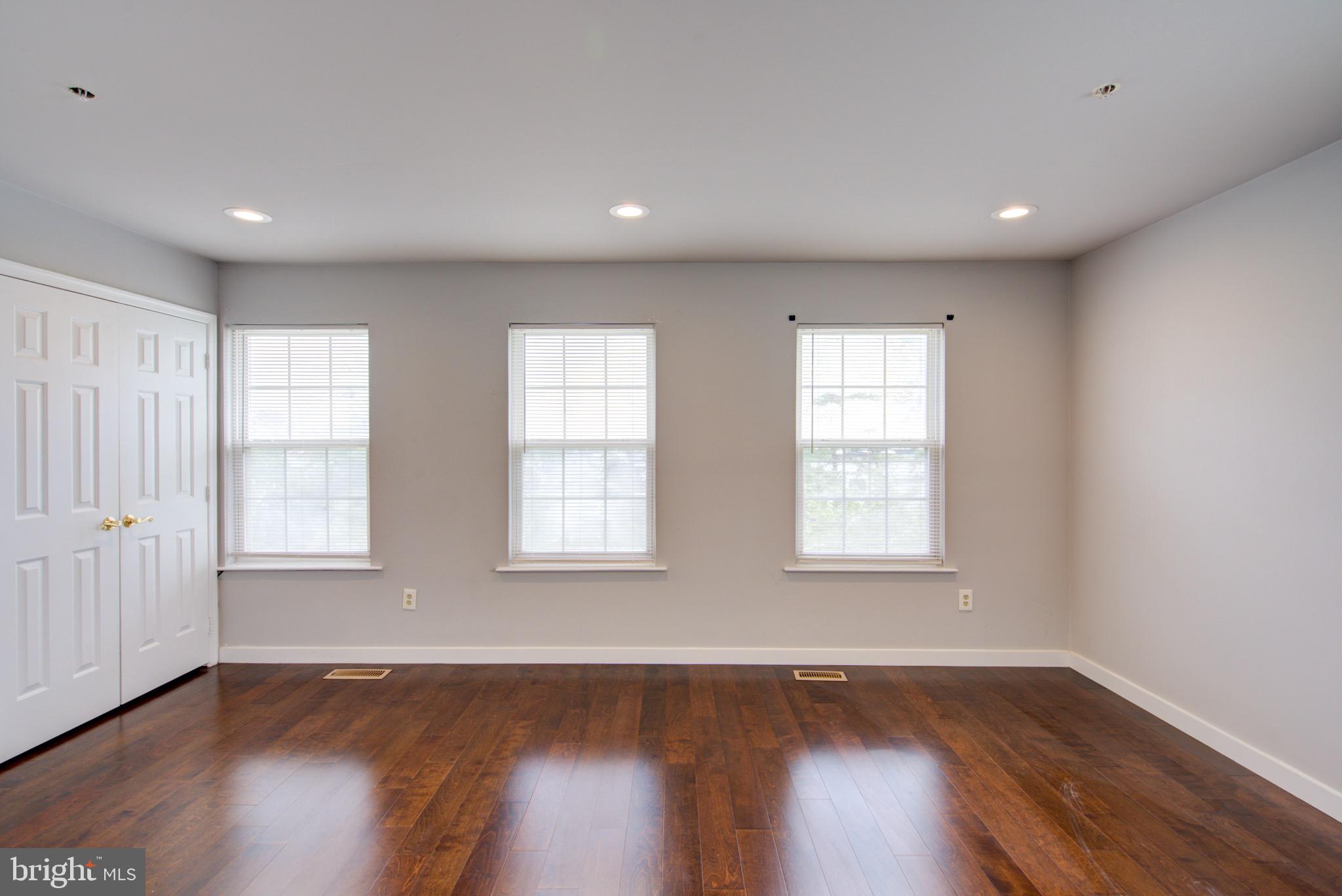 4304 Applegate Lane, Unit 2 Suitland, MD 20746 - Photo 16 of 27 a view of an empty room with wooden floor and window
