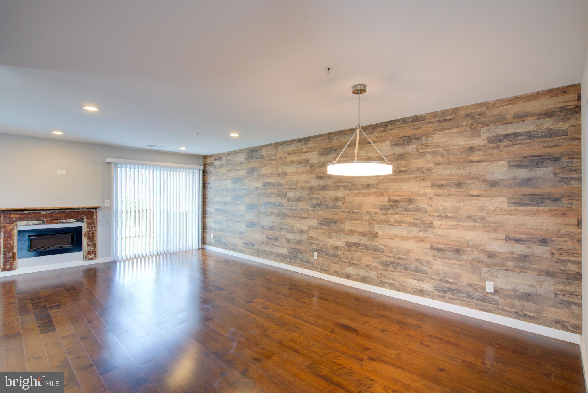 4304 Applegate Lane, Unit 2 Suitland, MD 20746 - Photo 4 of 27 a room with a wooden floor and a fireplace