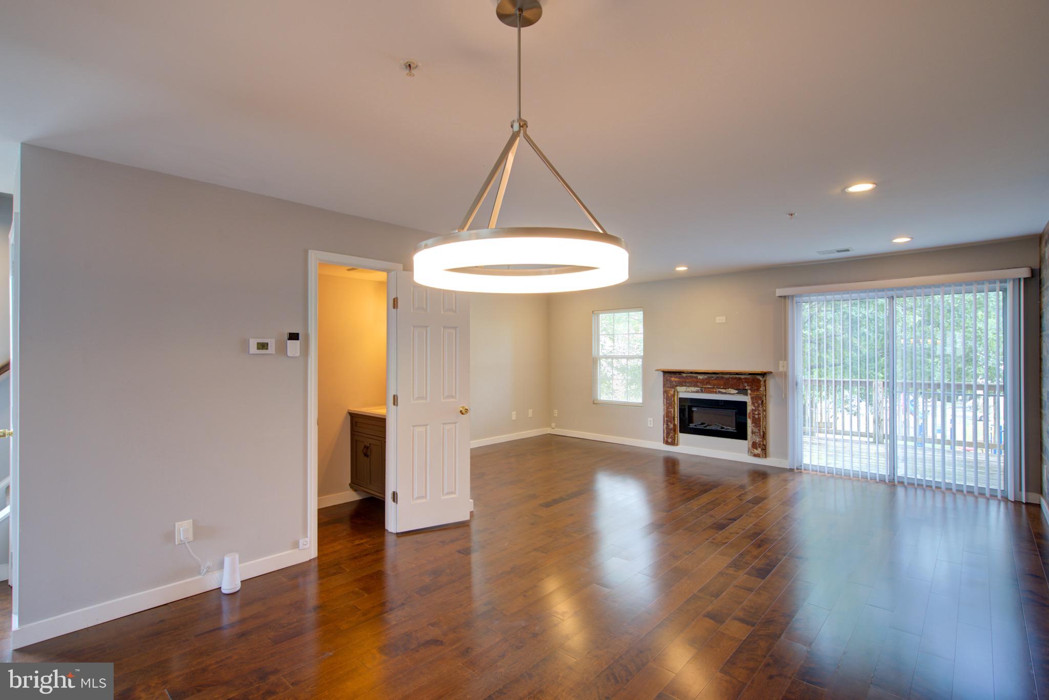 4304 Applegate Lane, Unit 2 Suitland, MD 20746 - Photo 6 of 27 a view of empty room with wooden floor and fireplace