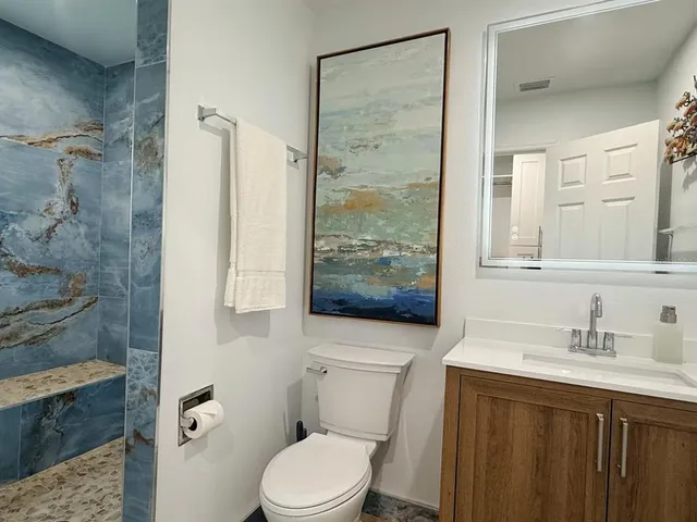 a kitchen with a refrigerator a microwave a sink and cabinets