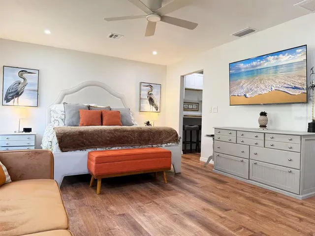 a bedroom with a bed and a wall painting