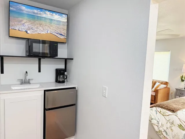 a kitchen with stainless steel appliances furniture dining table and wooden floor