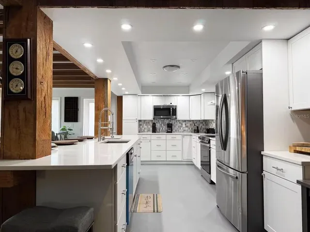 a kitchen with a sink stainless steel appliances and cabinets