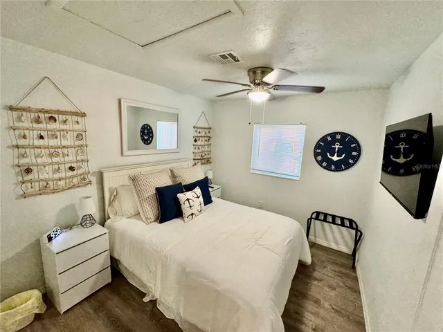 a bedroom with furniture and a wooden floor