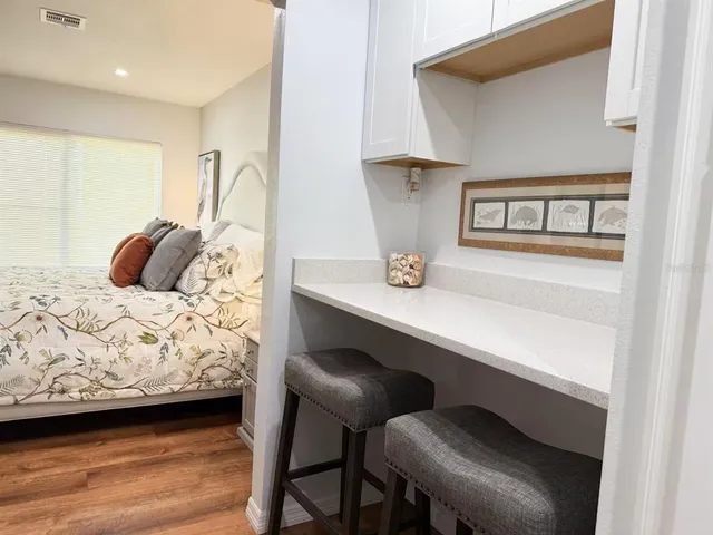 a kitchen with refrigerator and cabinets