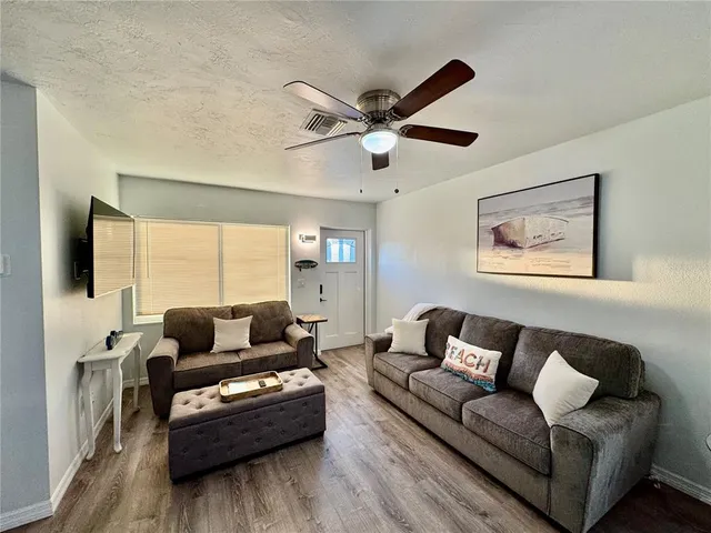 a kitchen with cabinets and a refrigerator