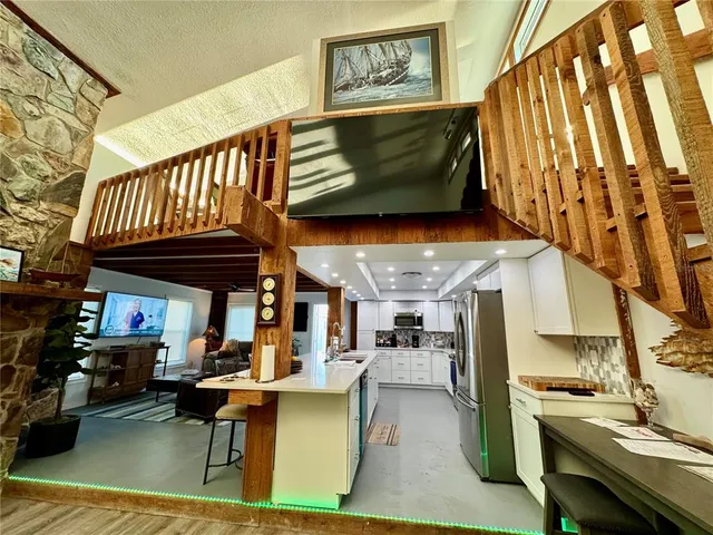 an outdoor living area with furniture and a fireplace