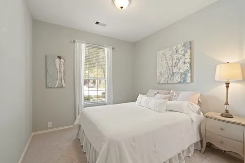 a bedroom with a bed and a lamp