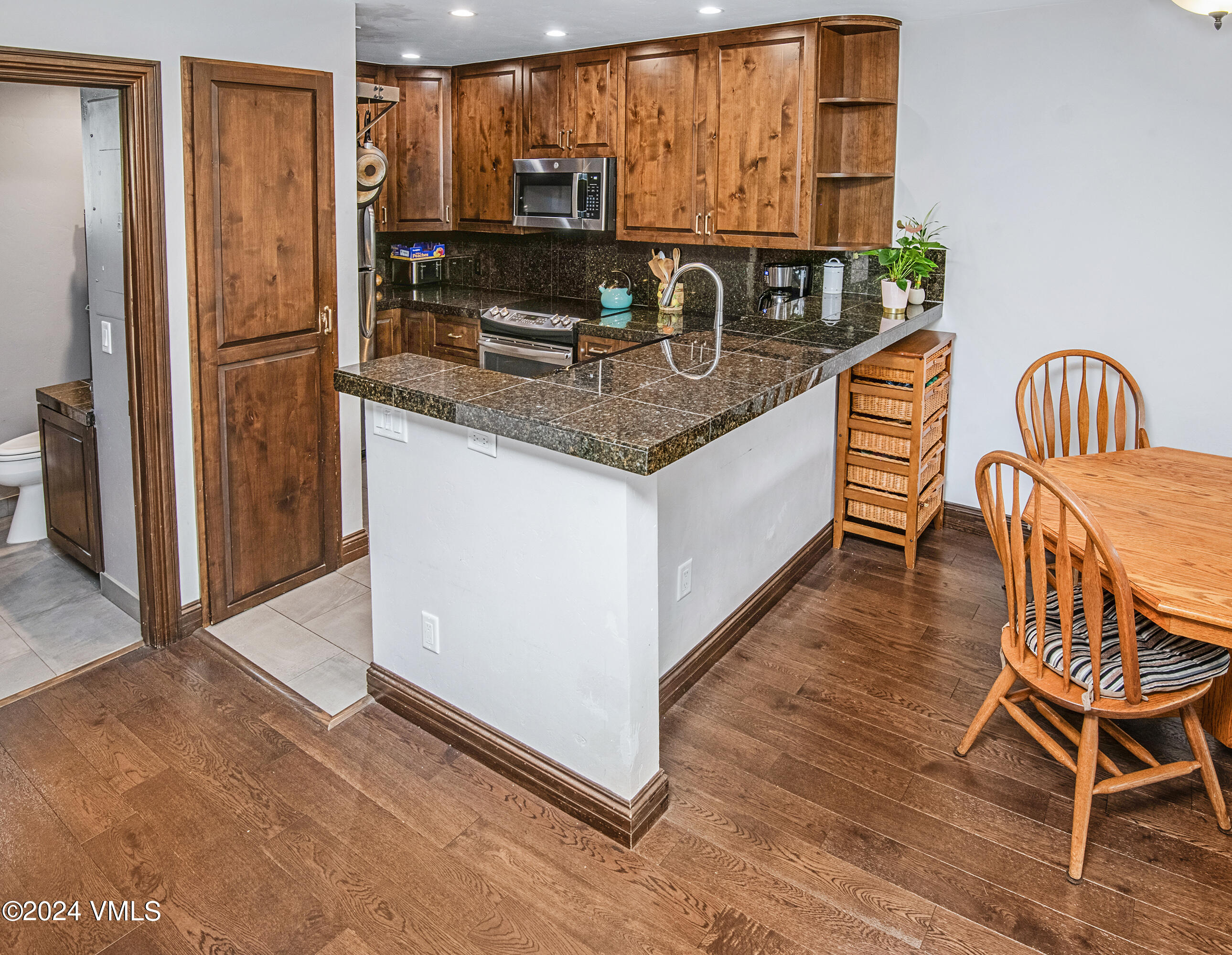 600 Nottingham Road, Unit 5 Avon, CO 81620 - Photo 4 of 13 a kitchen with stainless steel appliances granite countertop a stove a sink and a refrigerator