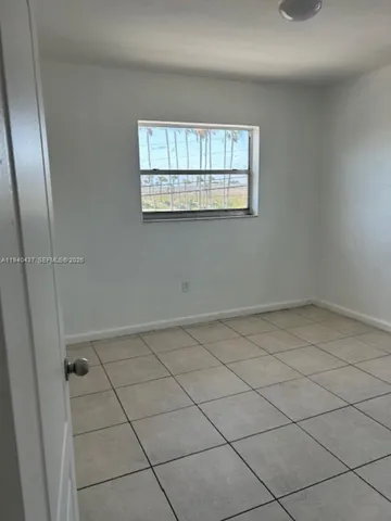 a kitchen with granite countertop white cabinets and sink