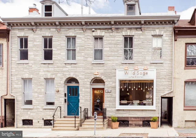 a view of a a dining room with furniture window and wooden floor
