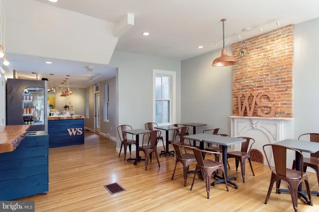 a view of a a dining room with furniture window and wooden floor