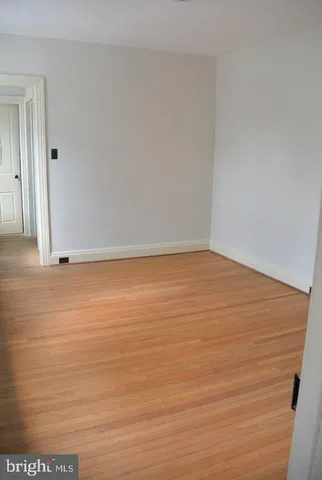 a view of wooden floor and chandelier in a room