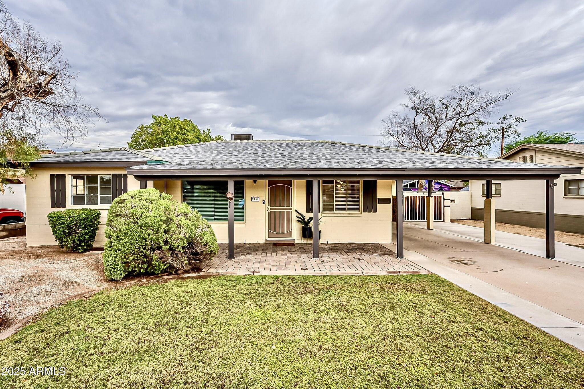 a front view of house with yard outdoor seating and barbeque oven