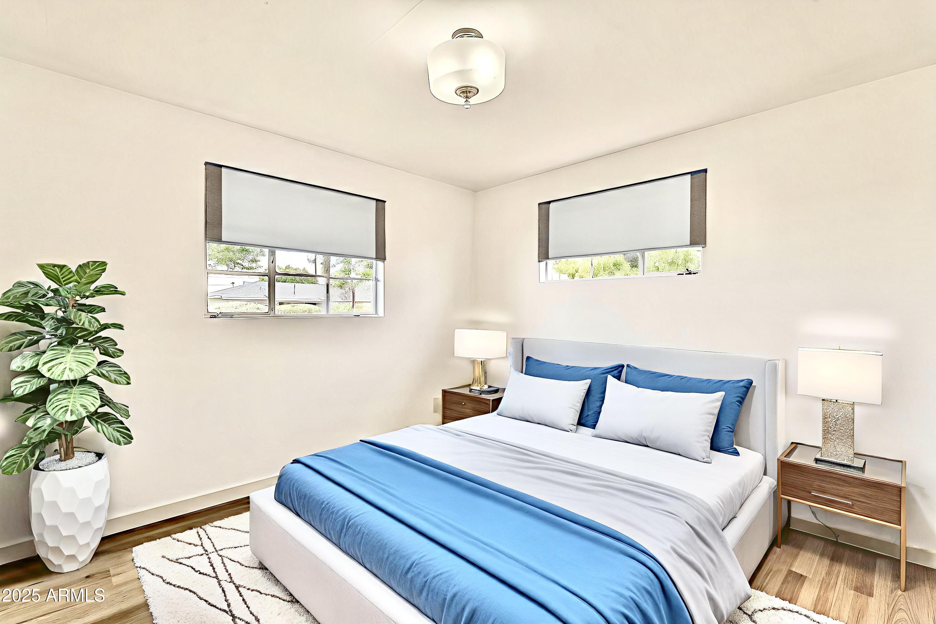 2150 West State Avenue Phoenix, AZ 85021 - Photo 20 of 32 a bedroom with bed and a potted plant