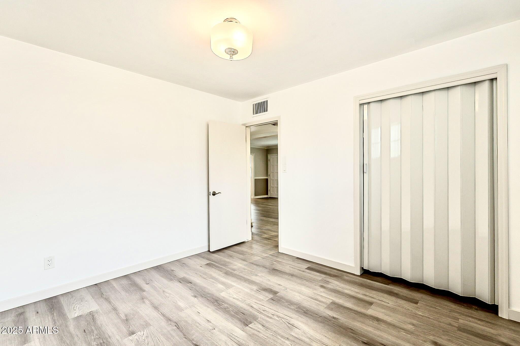2150 West State Avenue Phoenix, AZ 85021 - Photo 25 of 32 a view of a room with wooden floor and entryway