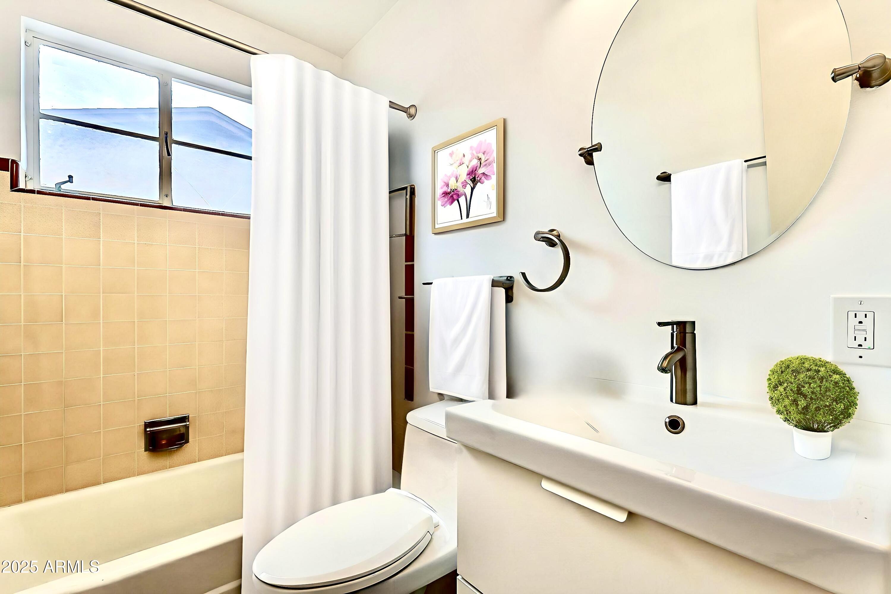 2150 West State Avenue Phoenix, AZ 85021 - Photo 26 of 32 a bathroom with a sink a toilet and shower curtain