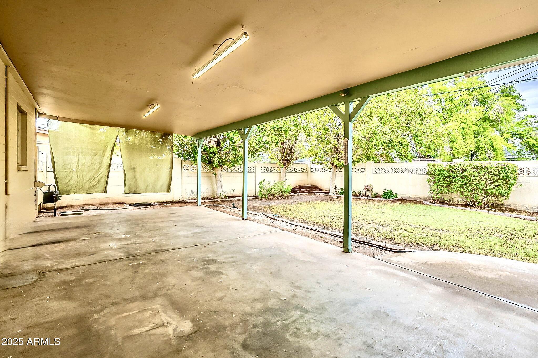 2150 West State Avenue Phoenix, AZ 85021 - Photo 30 of 32 a view of an empty room and a yard with large trees