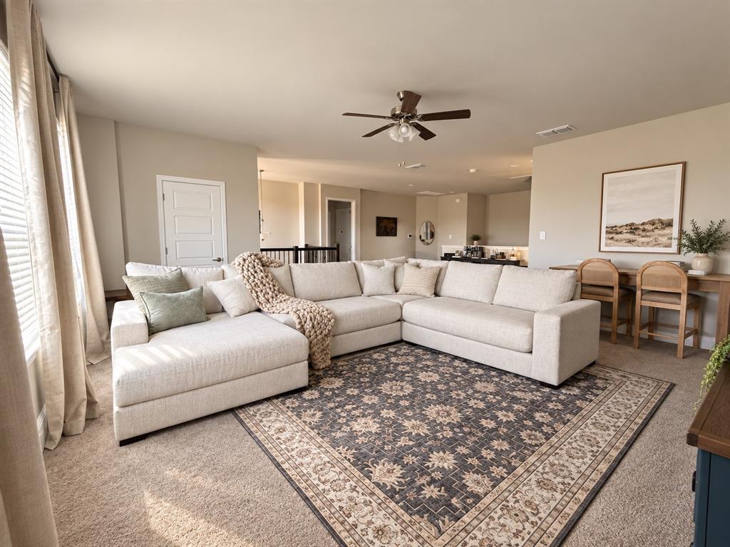 1605 Buzzard Road Denton, TX 76205 - Photo 5 of 27 Neutral-toned walls complement the carpeted flooring throughout the space