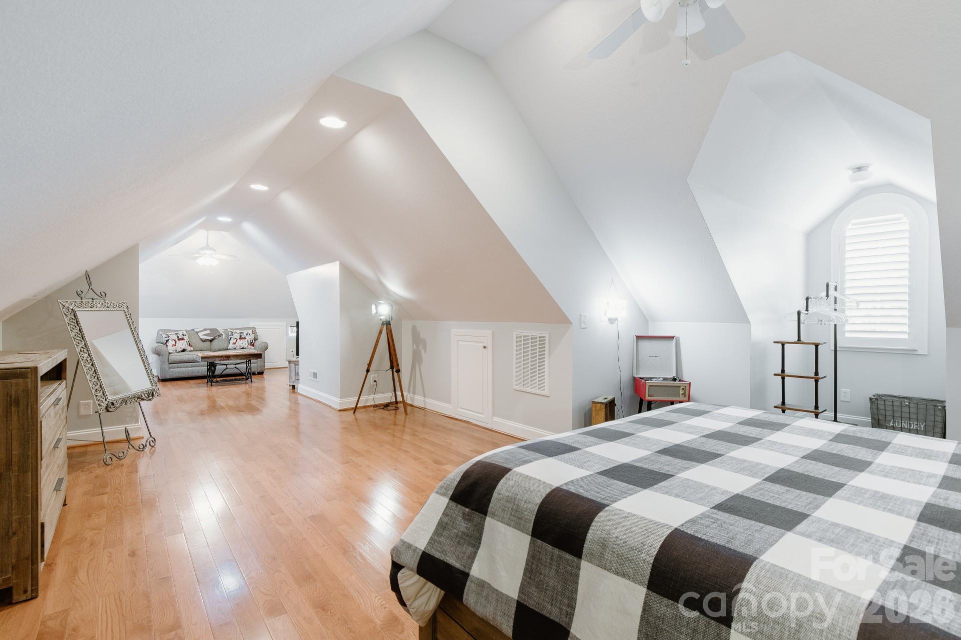 110 Mandy Lane Tryon, NC 28782 - Photo 34 of 48 a spacious bedroom with a bed and wooden floor