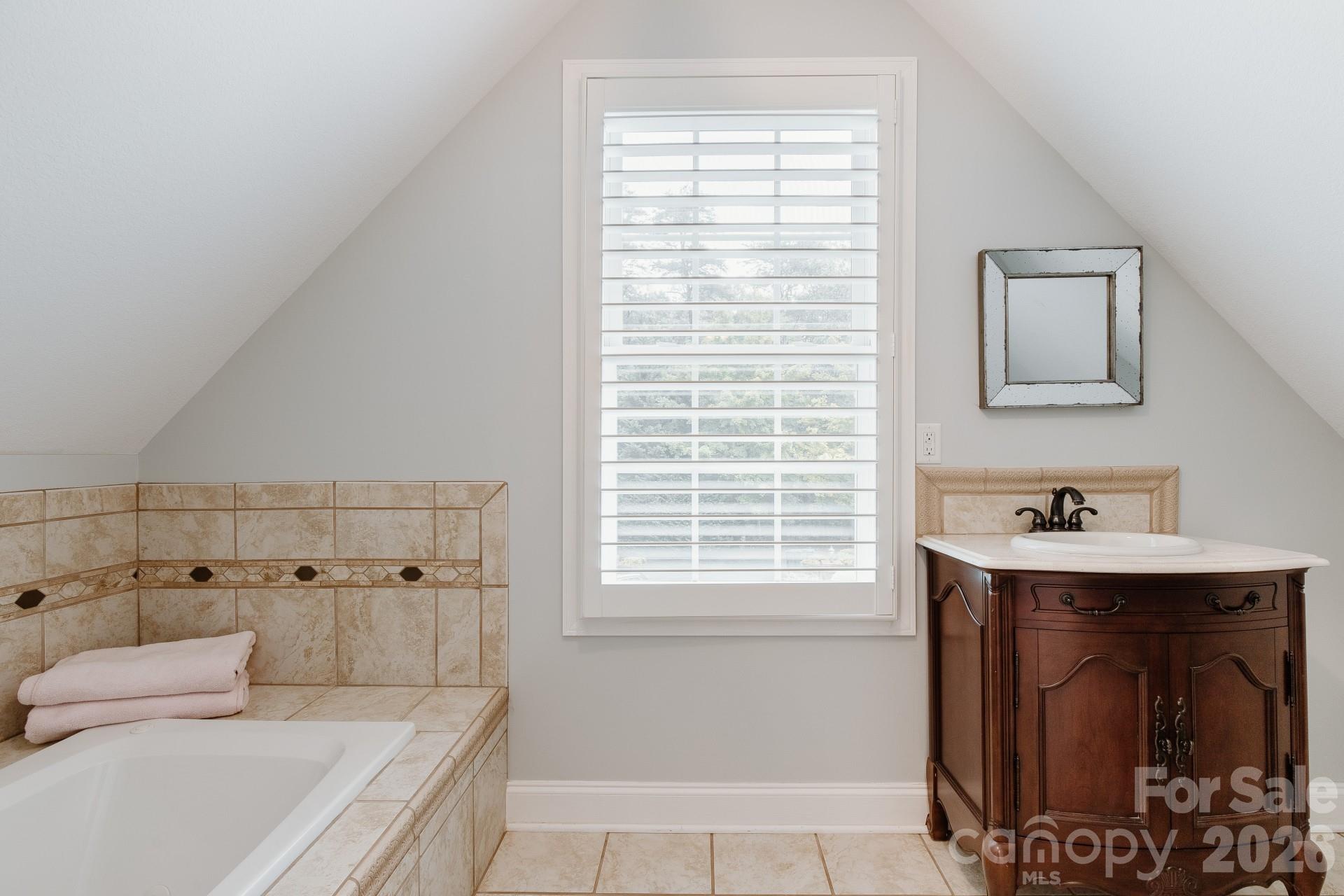 110 Mandy Lane Tryon, NC 28782 - Photo 37 of 48 a bathroom with a bathtub sink and mirror