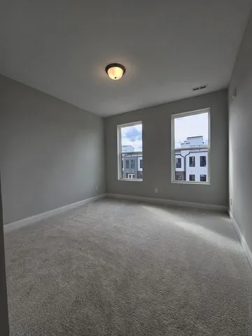 an empty room with windows and entrance
