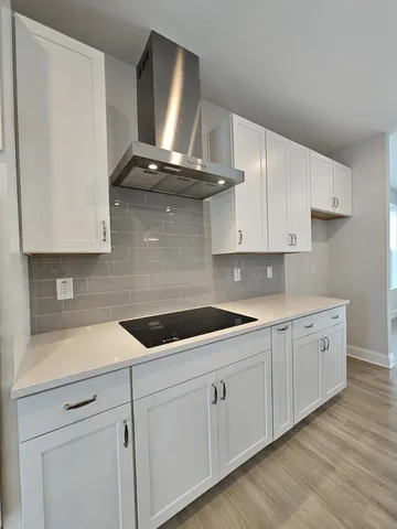 a view of a living room kitchen and a wooden floor