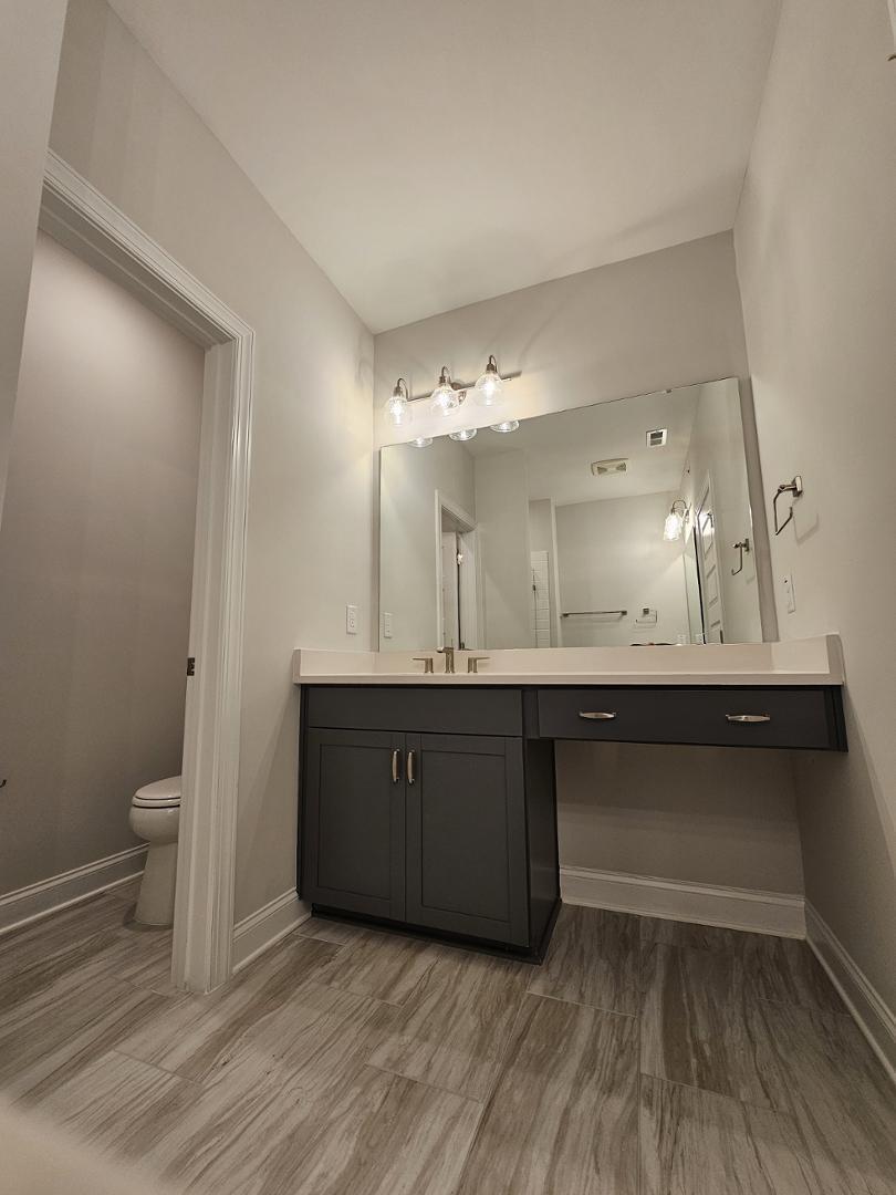 1202 Coach Station Alley, Unit 201 Raleigh, NC 27601 - Photo 9 of 16 a bathroom with a sink and a mirror