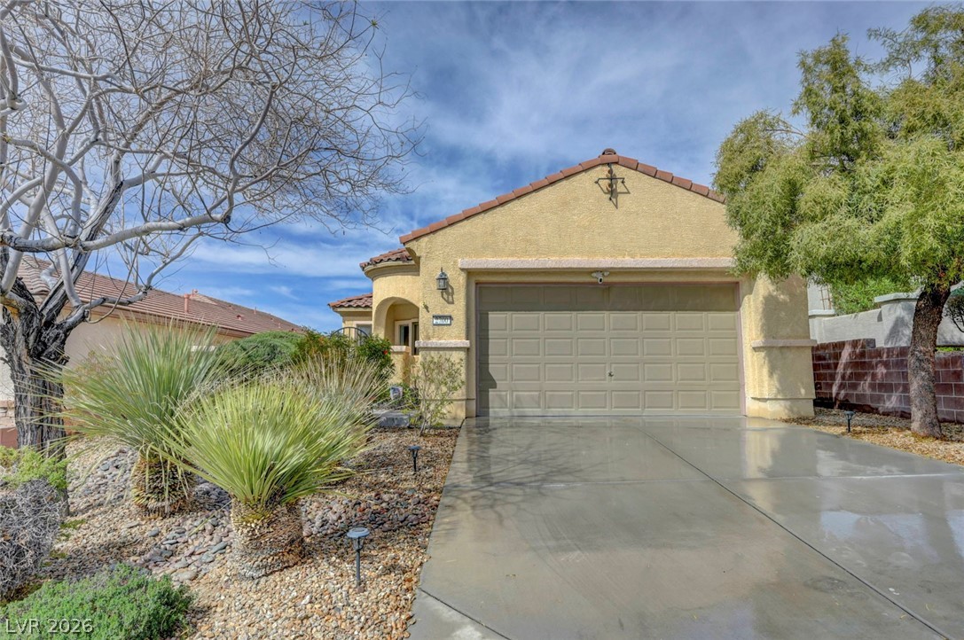 2700 Rue Montpellier Avenue Henderson, NV 89044 - Photo 1 of 39 Mediterranean / spanish home featuring a garage, concrete driveway, stucco siding, and a tiled roof