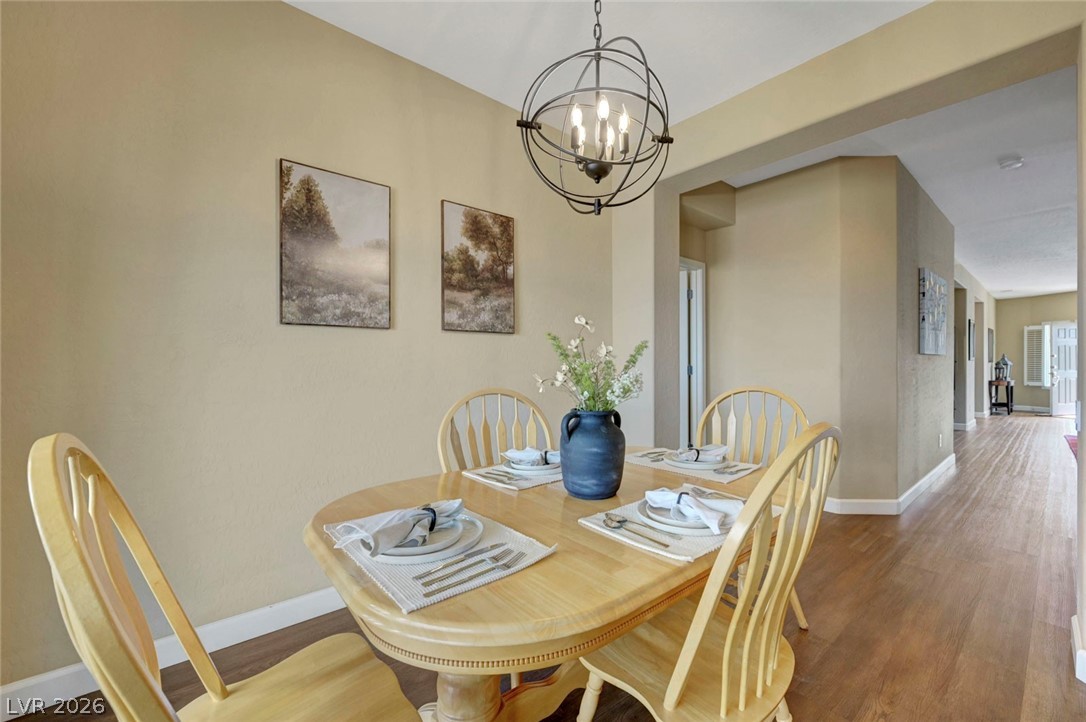 2700 Rue Montpellier Avenue Henderson, NV 89044 - Photo 12 of 39 Dining space with wood finished floors and a chandelier