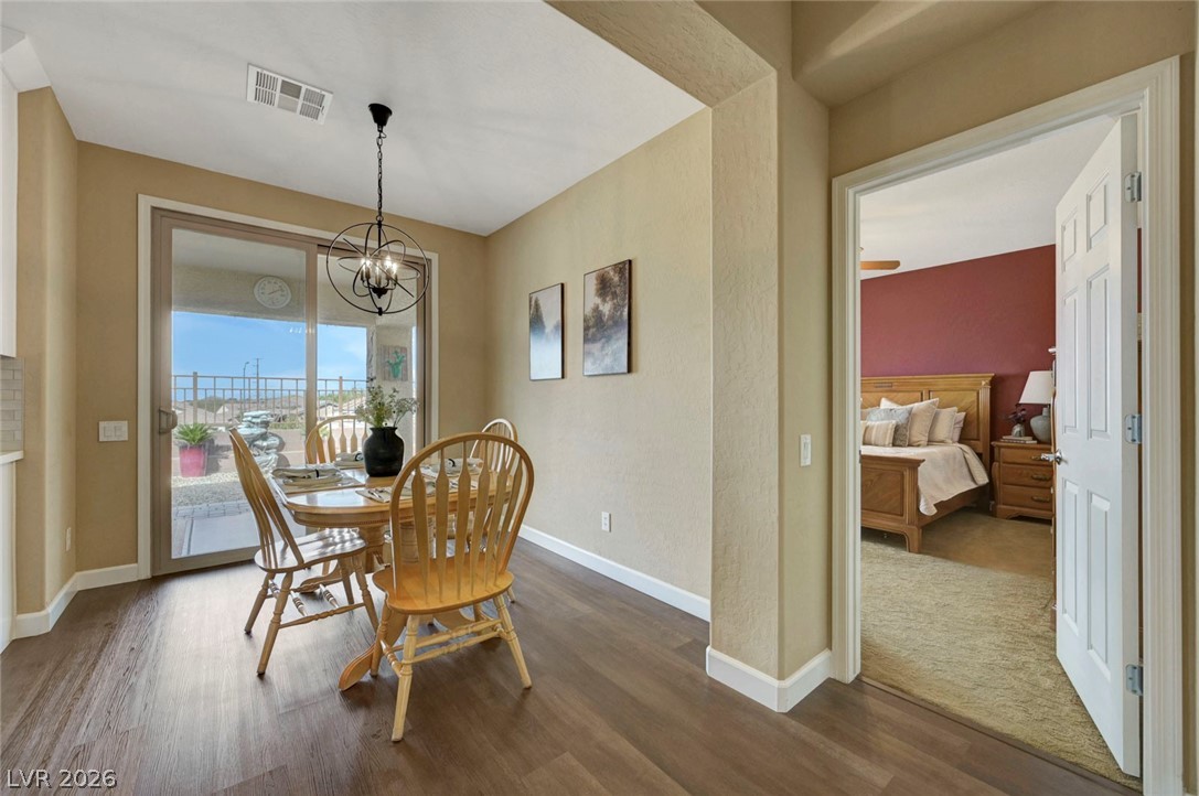 2700 Rue Montpellier Avenue Henderson, NV 89044 - Photo 20 of 39 Dining space featuring dark wood-style floors and a chandelier