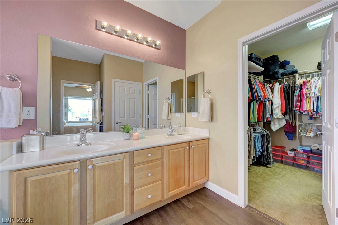 2700 Rue Montpellier Avenue Henderson, NV 89044 - Photo 24 of 39 Bathroom with double vanity, a walk in closet, and light wood-style floors