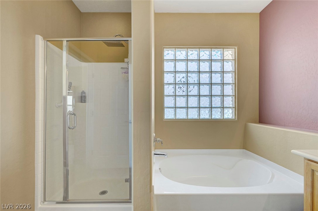 2700 Rue Montpellier Avenue Henderson, NV 89044 - Photo 26 of 39 Bathroom featuring vanity, a bath, and a shower stall