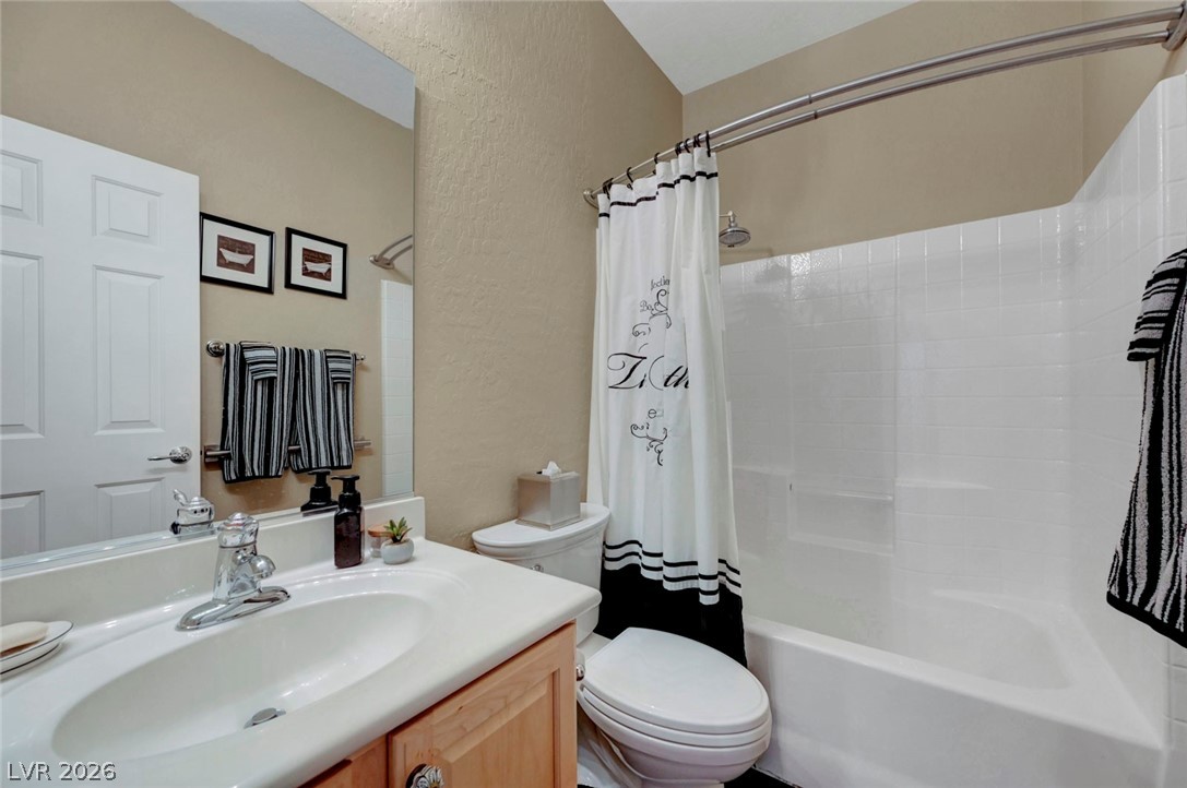 2700 Rue Montpellier Avenue Henderson, NV 89044 - Photo 30 of 39 Bathroom with vanity, a textured wall, and shower / tub combo with curtain