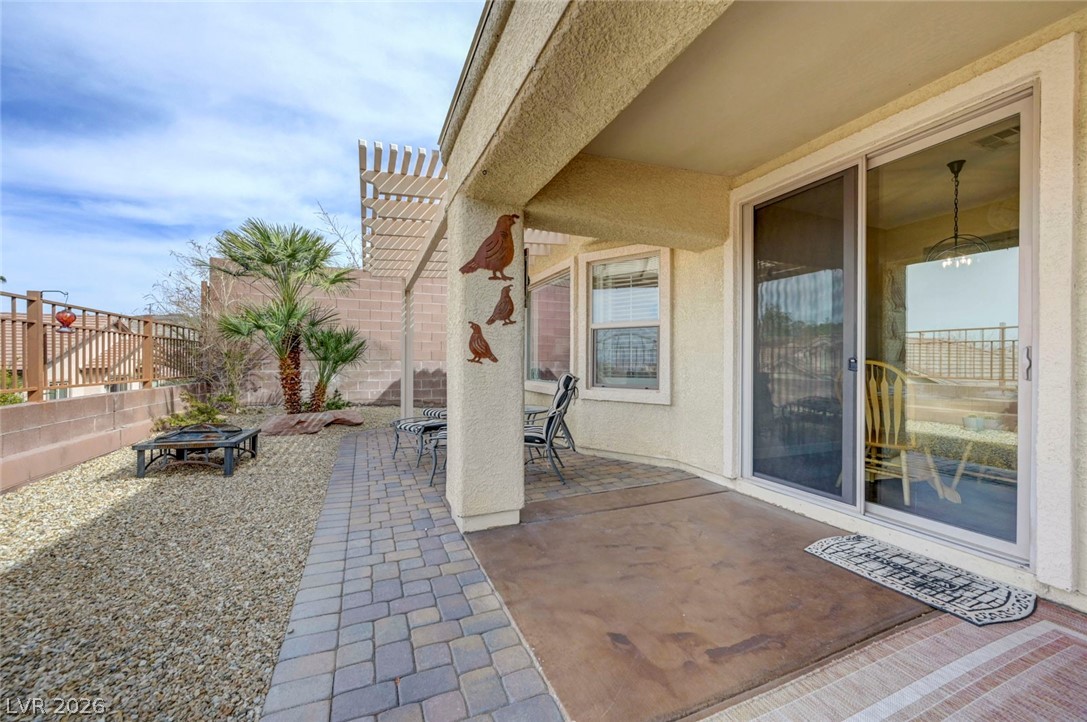 2700 Rue Montpellier Avenue Henderson, NV 89044 - Photo 33 of 39 Fenced backyard featuring a patio area, outdoor dining area, and an outdoor fire pit