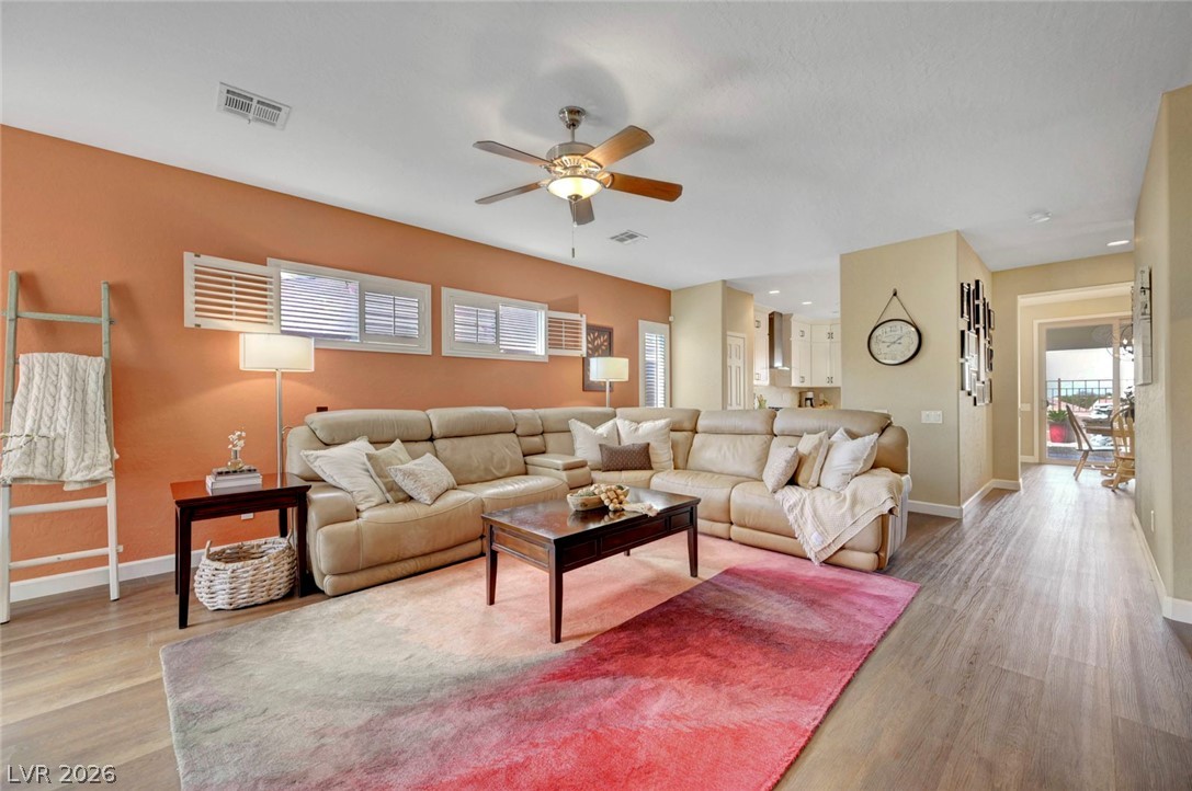 2700 Rue Montpellier Avenue Henderson, NV 89044 - Photo 10 of 39 Living room featuring ceiling fan, plenty of natural light, and light wood-style flooring
