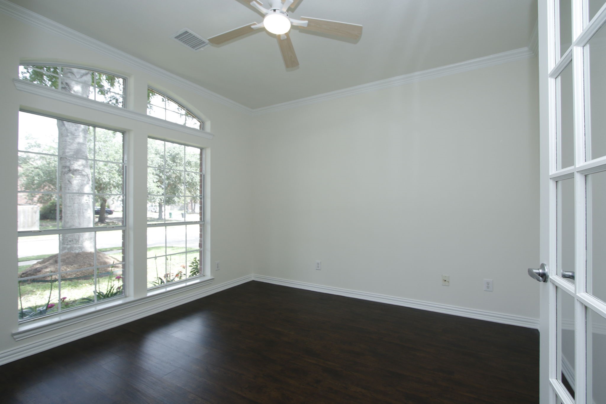 1210 Berwick Manor Court Spring, TX 77379 - Photo 12 of 50 an empty room with wooden floor fan and windows