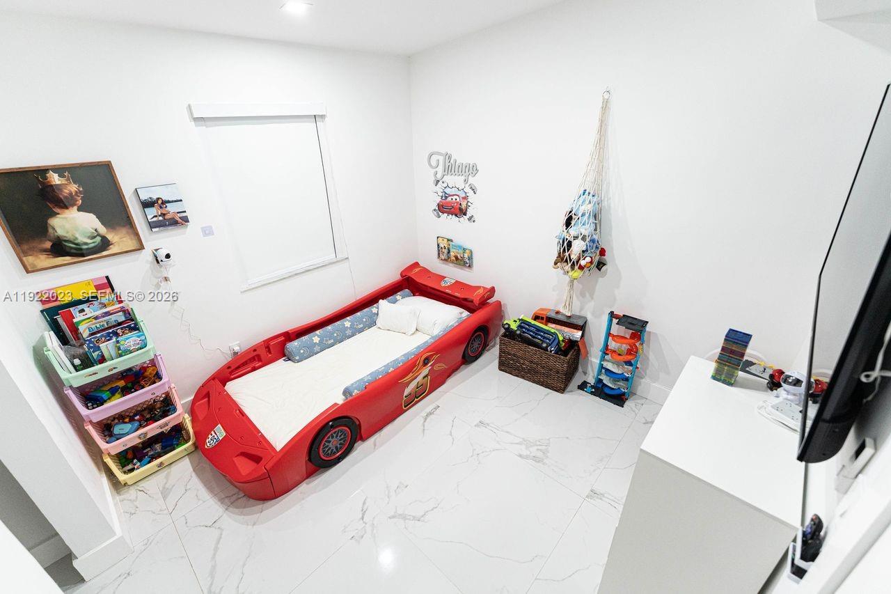 5200 Southwest 114th Court Miami, FL 33165 - Photo 16 of 36 a bedroom with furniture and a wooden floor